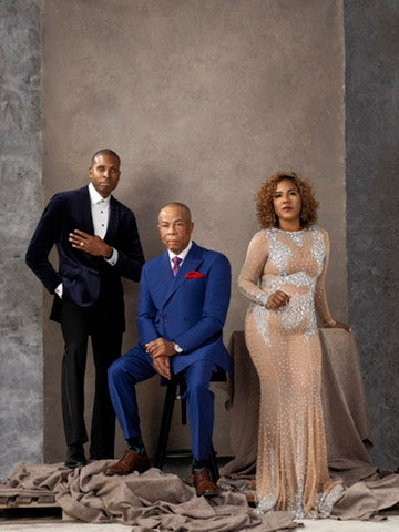 Alex Lexington founders in formal attire against a textured gray wall.