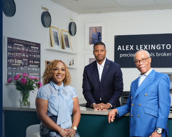 Three members of the Alex Lexington family at the showroom counter beneath the Alex Lexington sign in Chamblee, Georgia