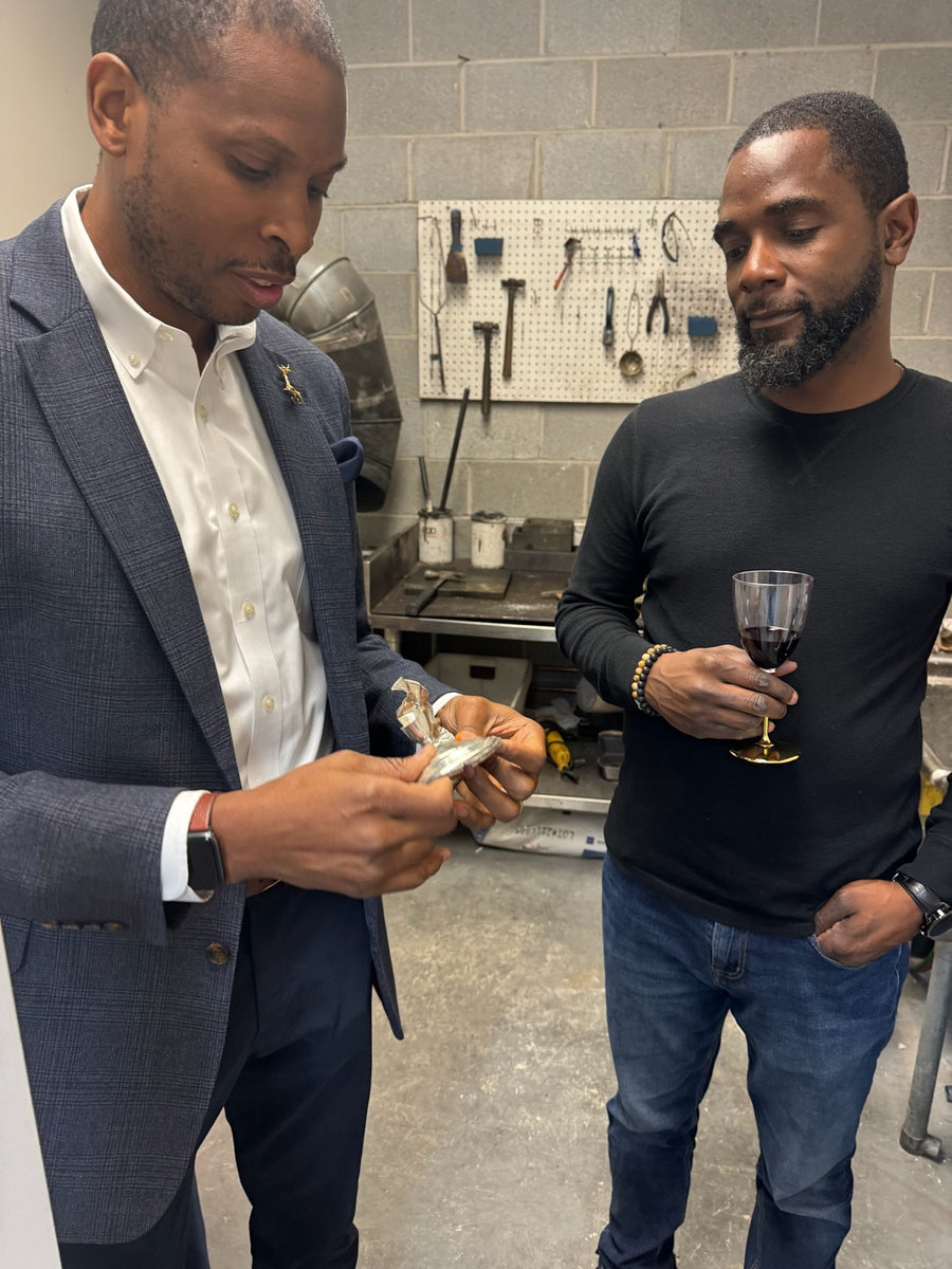 Andre inspecting a poured silver button in the smelting room