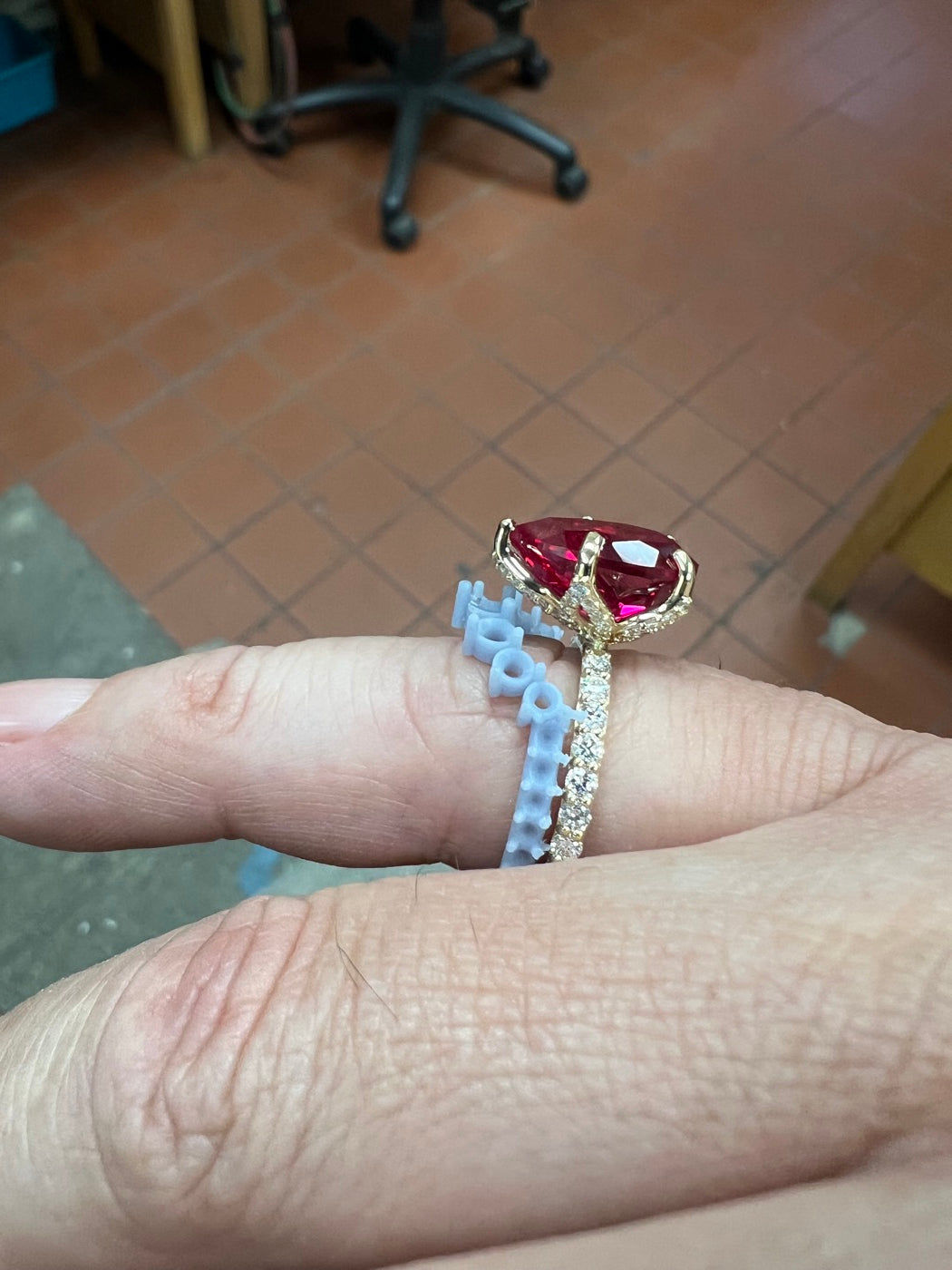 A pear-cut ring being sized at the bench