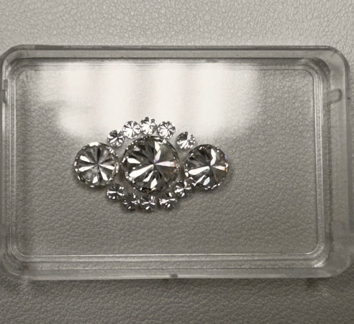 Loose diamonds laid out in a gem box before setting