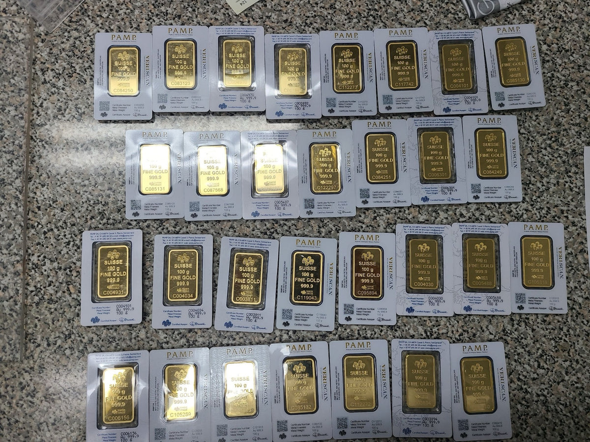 One hundred gram gold bars in assay on the counter