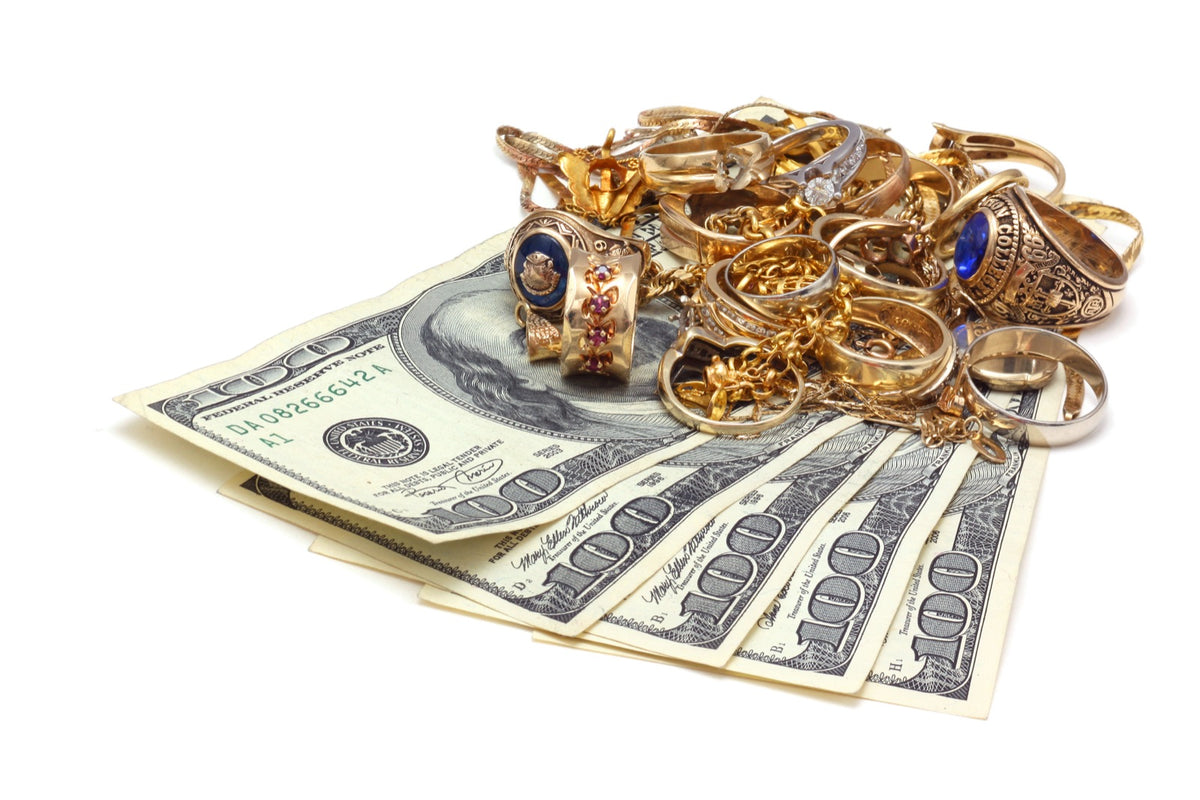 Karat gold jewelry and cash on the buy counter